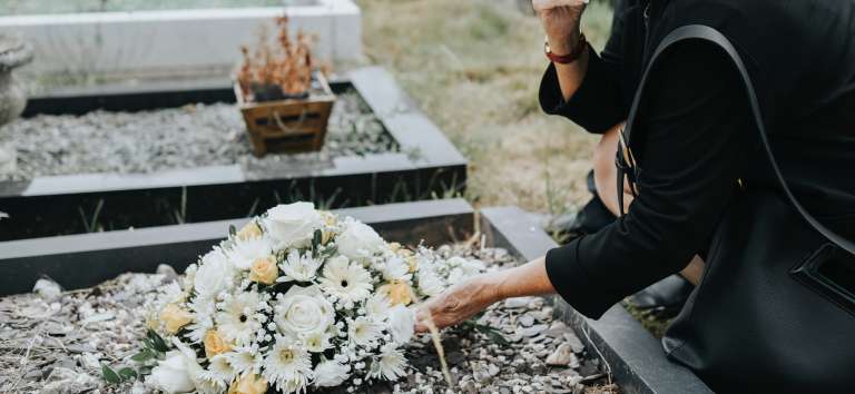 Woman standing over grave