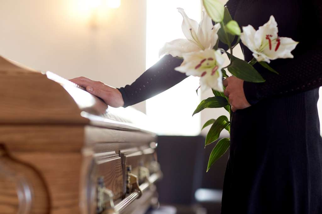 Woman touching casket