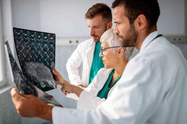 doctors examining an x-ray report in hospital