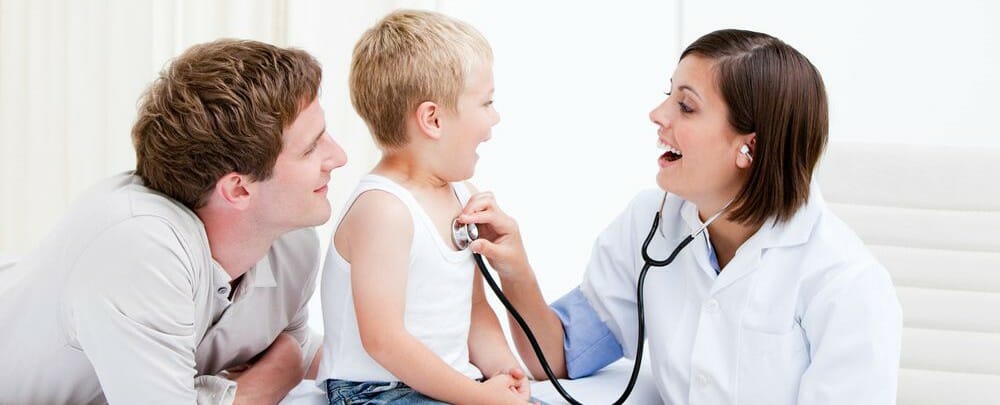 A photograph of a child being examined by a Doctor