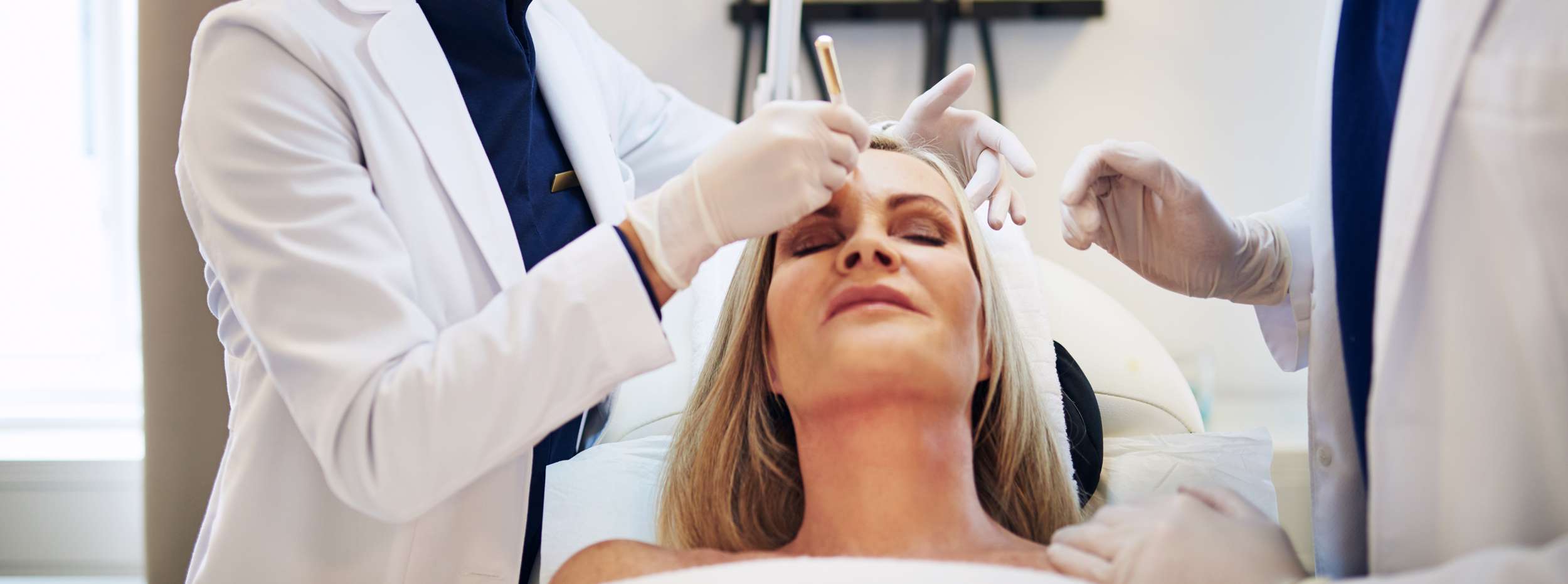 woman lying on clinic table before cosmetic surgery