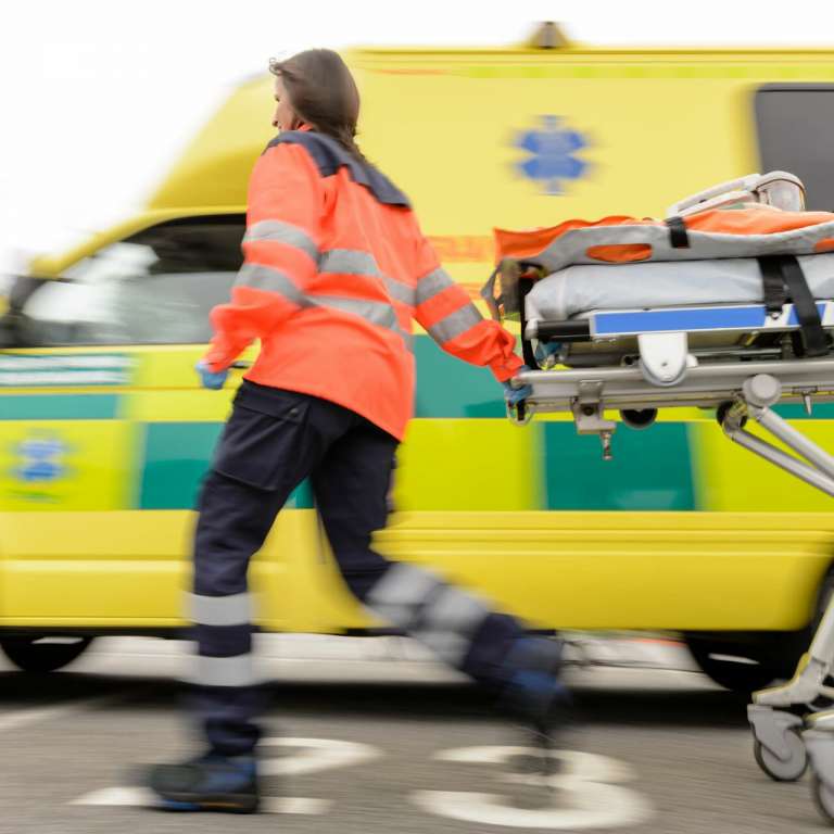 A photograph of a paramedic in front of an ambulance, as investigations are being undertaken in to why 111 delayed ambulances.