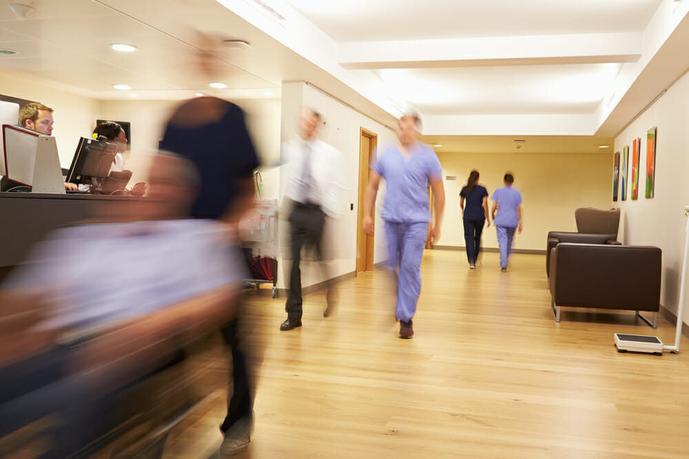 A photograph of a busy hospital corridor, taken with a slow shutter, so thee is some motion blur. This is on the same hospital mentoned in the article, as Mid Staffordshire Trust has been Fined £500,000