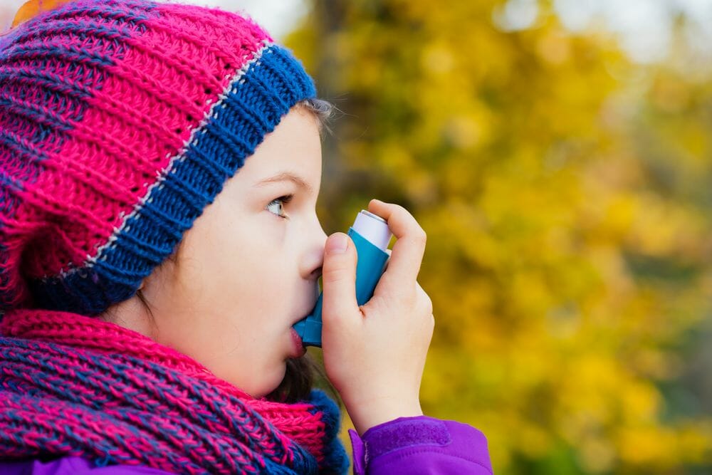 A photography of child using an inhaler. As research suggests that half a million children could have been wrongly diagnosed with asthma.