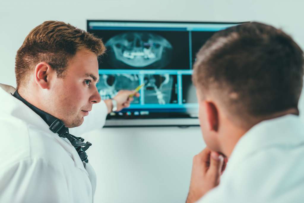 Dentists Having a Conversation over Patient X-Rays