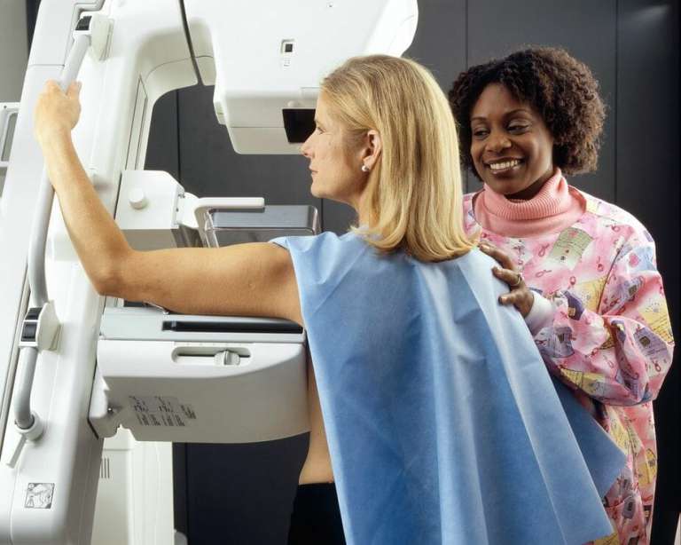 A photograph of a lady having a mammogram in an article about a national breast screening programme failure