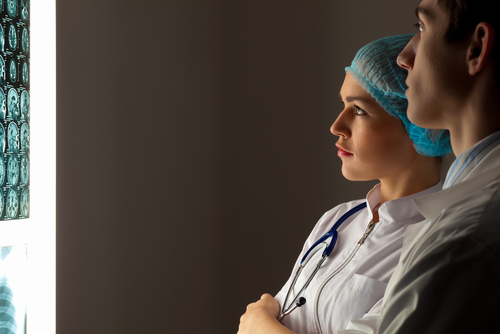 Two surgeons looking at a scan