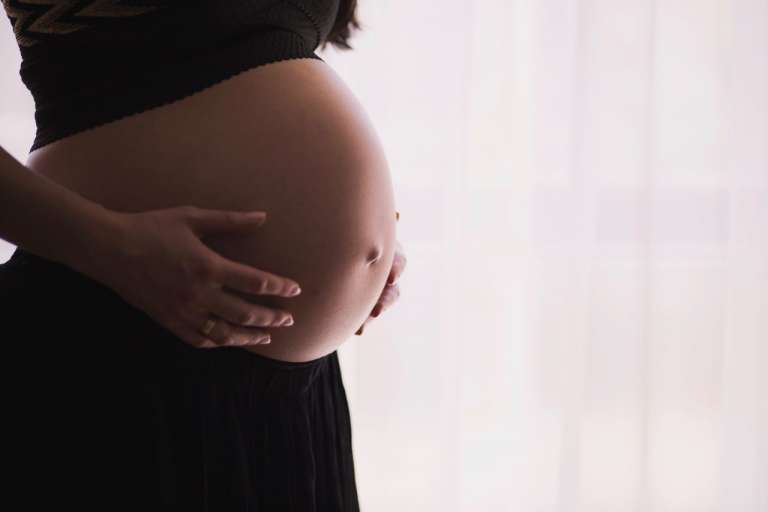 A photograph of a pregnant lady holding bump, as the NHS announce plan to expand their mental health network for new and expectant mothers