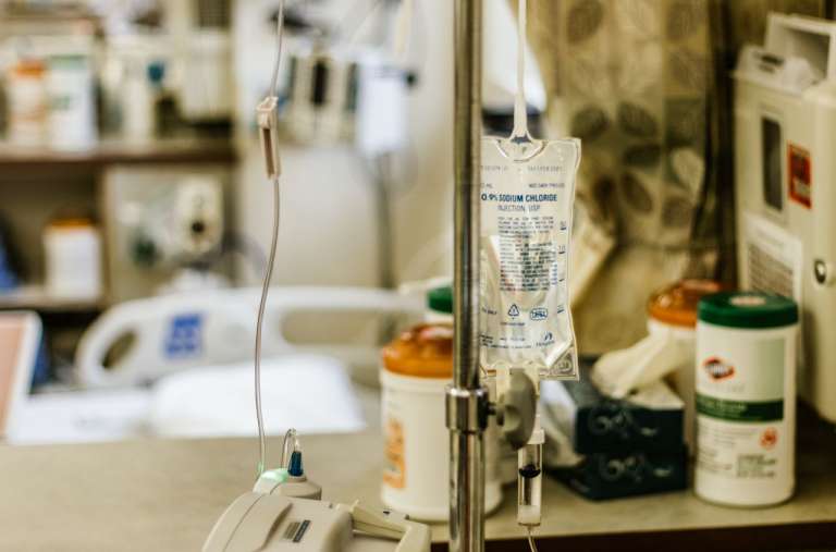 Intravenous (IV) Sodium Chloride on a stand, in a medical setting.