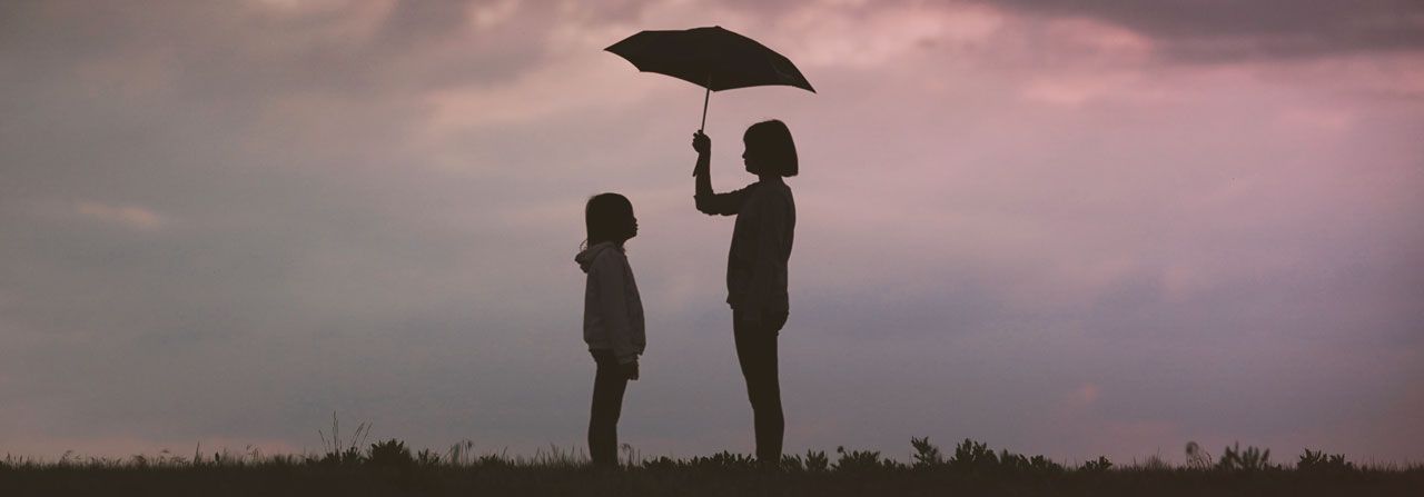 People Sheltering under an umbrella