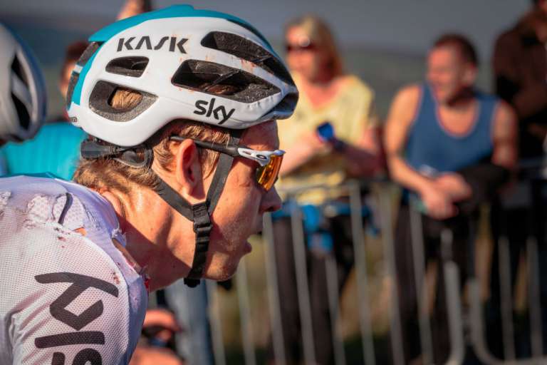 Close up of Team Sky male cyclist's face. After a Crash - minor damage and blood to clothing. In the debate about whether to wear a bike helmet - images like this probably support the case for wearing one.