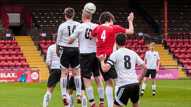 Football player heading the ball after a corner. A recent study has revealed that professional footballers professional footballers are more likely to die from Alzheimer's.