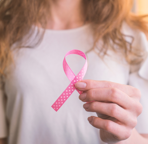 breast cancer patient holding pink ribbon