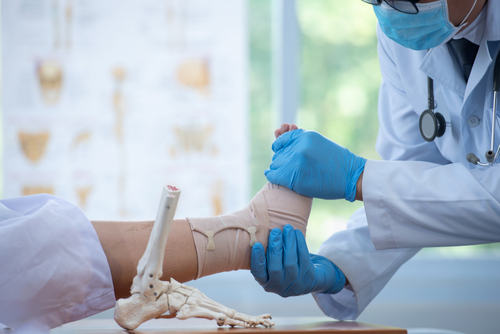 doctor examining patient's foot before foot surgery