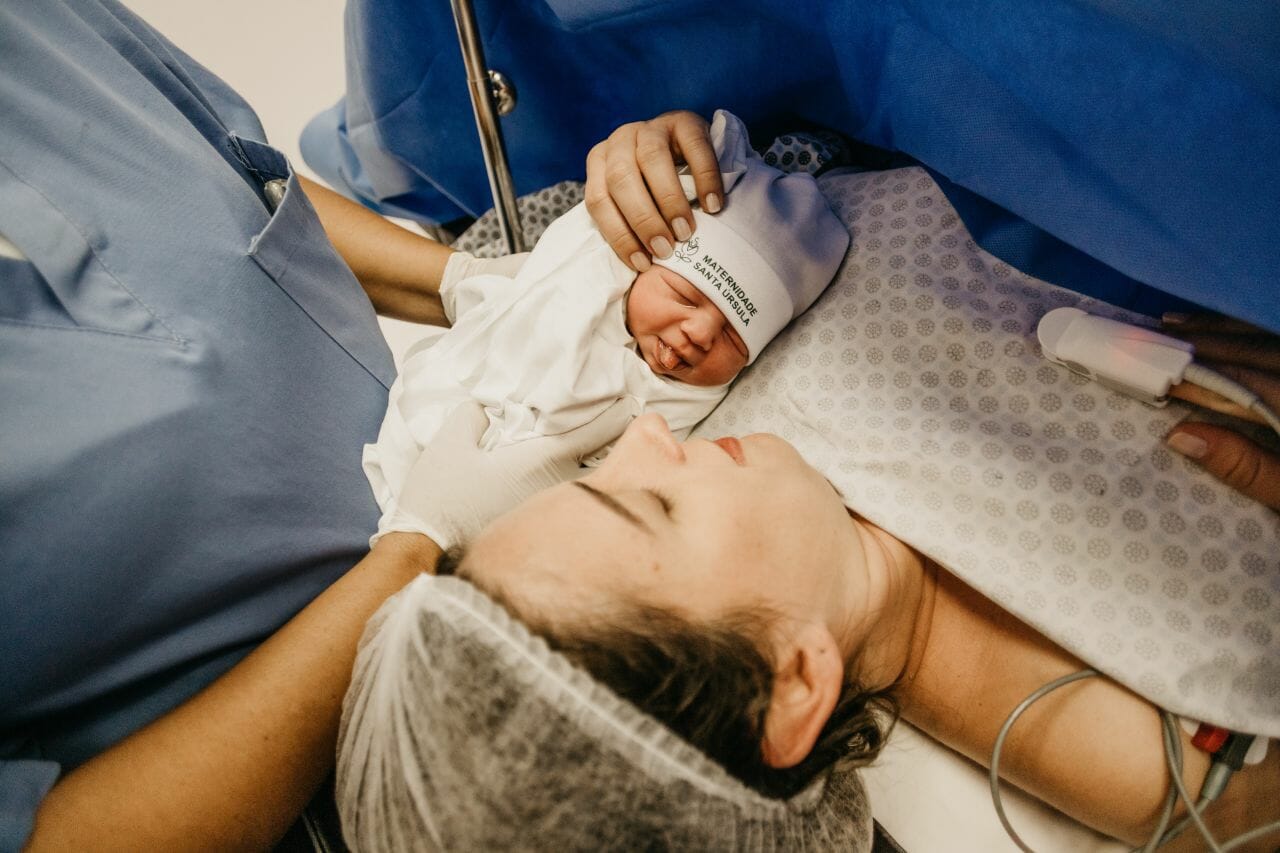 Baby beside woman after birth