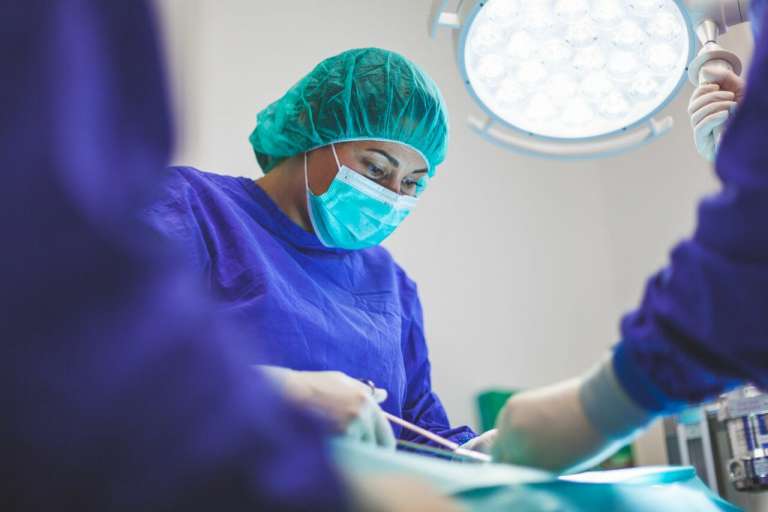 A photograph of a doctor operating in theatre. This is similar to the work that the Doctors at the centre of the St. George's Hospital investigation would have done.