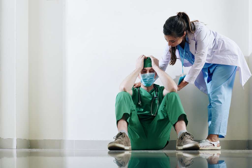 reassuring stressed young surgeon