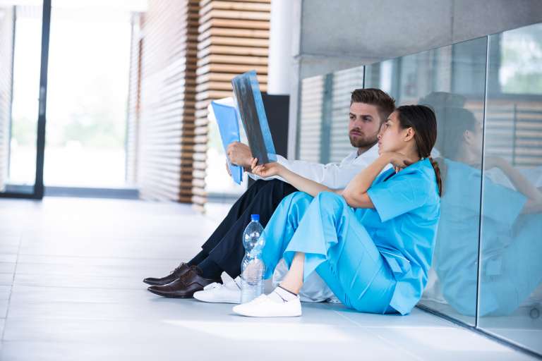 stressed doctor and nurse looking at xrays