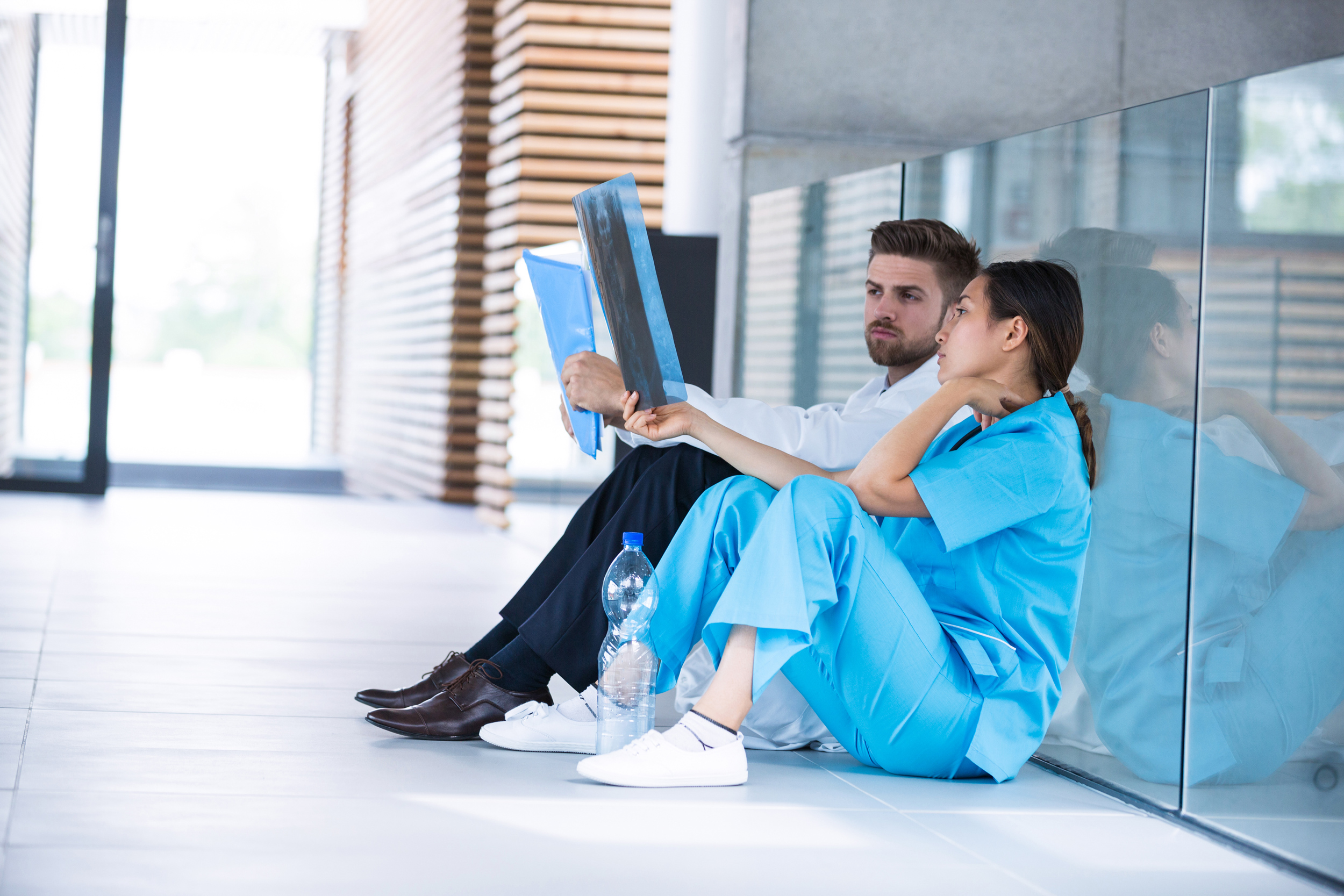 stressed doctor and nurse looking at xrays