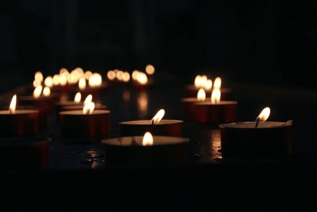 A number of small candles burning