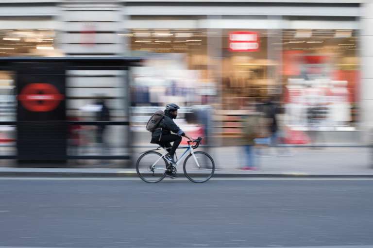 A cyclist riding in an urban area. One of the main beneficiaries of at system of presumed liability for cyclists would be urban cyclists like this.