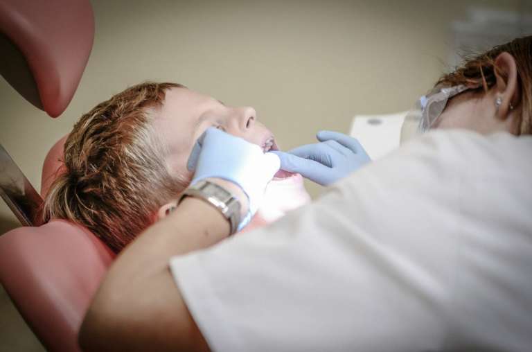 A dentist checking a patient’s teeth. Dentists reopen in England and Wales this week, so check-ups like this will not be far away.