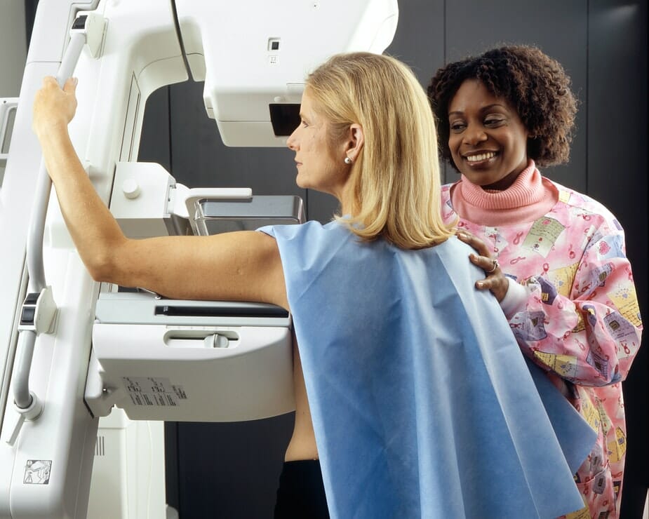 A photo of a lady having a mammogram. Part of vital cancer screening which is crucial to stop unnecessary cancer deaths