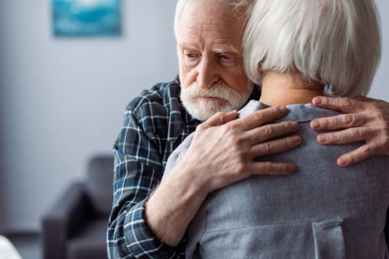 woman hugged by husband