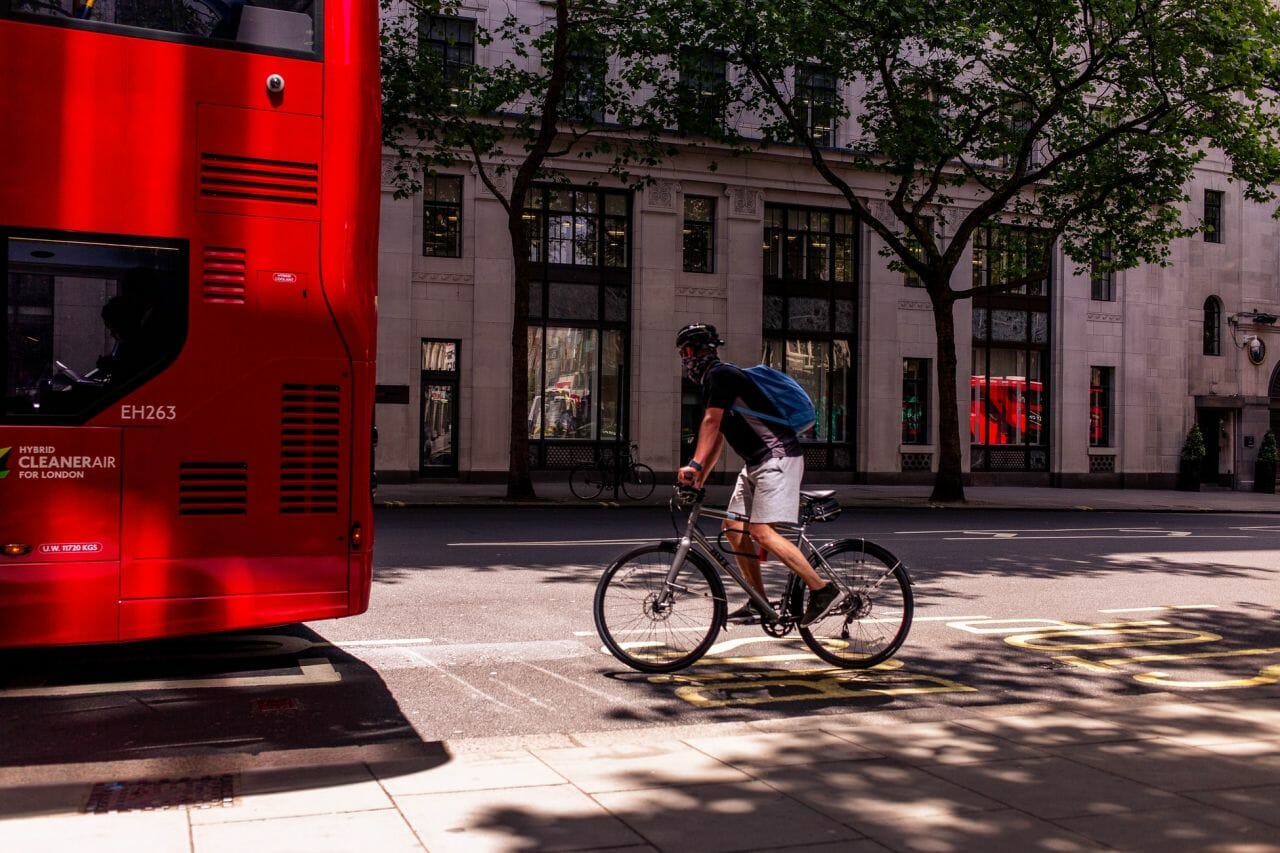 A photograph of a cyclist, riding behind a bus, in London. This is the type of rider that the review of The Highway Code looks to protect - along with other vulnerable road users.