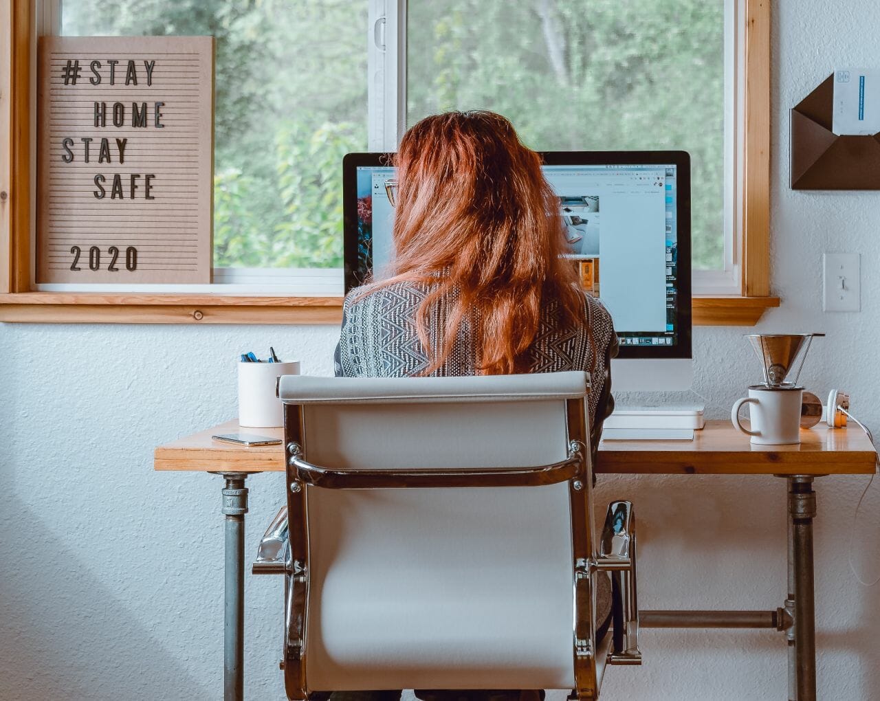 A photograph of a lady working at a computer, from home. Pryers staff worked form home during the corona virus lockdown.