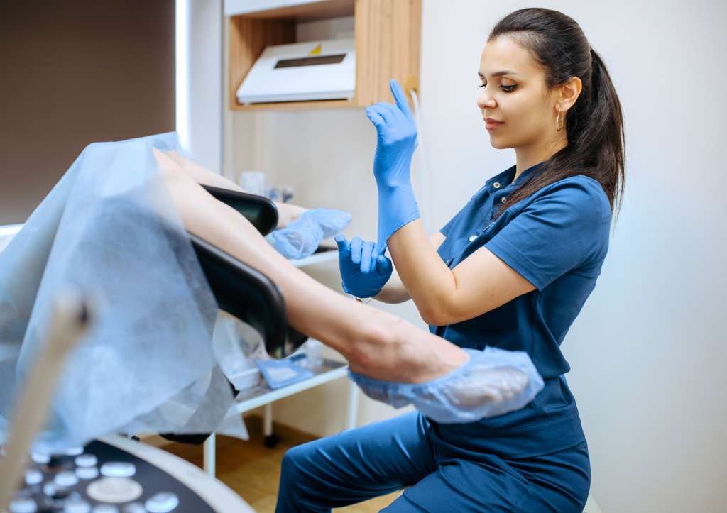 female gynecologist and patient in chair exam