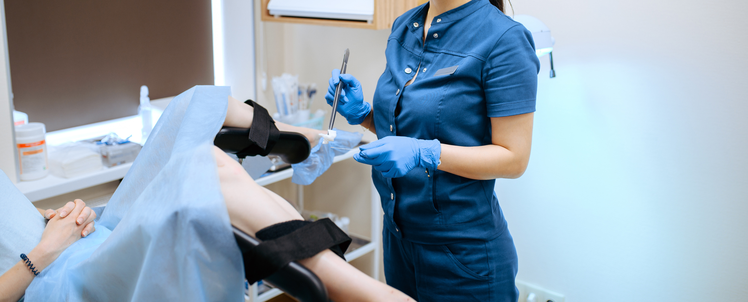 female gynecologist in gloves and uniform on exam