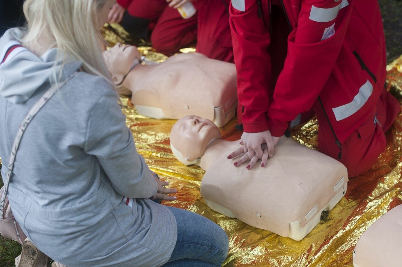 A person demonstrating CPR on a medical dummy. Do Not Resuscitate Decisions were inappropriately applied during the pandemic, potentially costing lives.