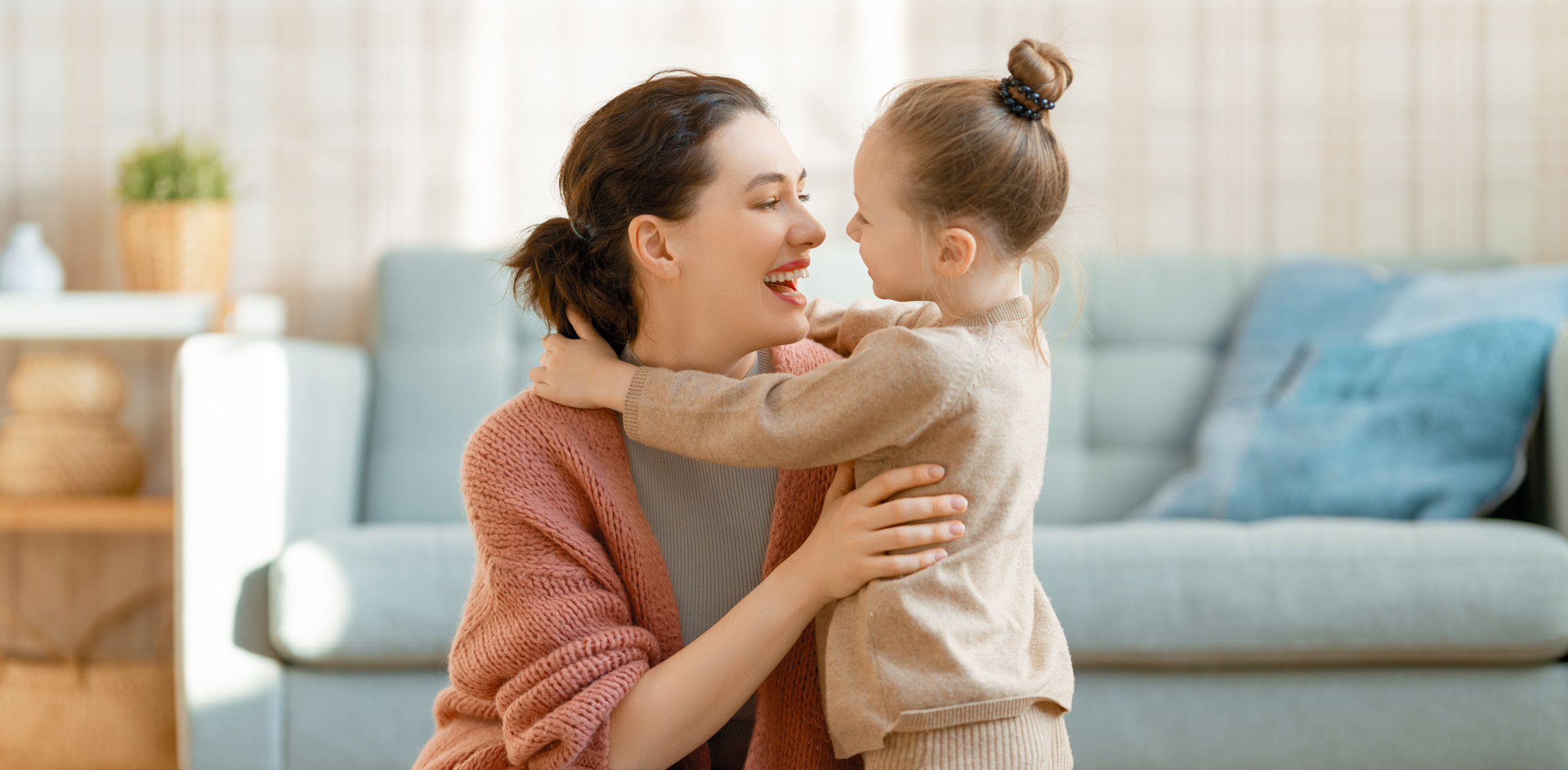 Mom and her daughter smiling and hugging