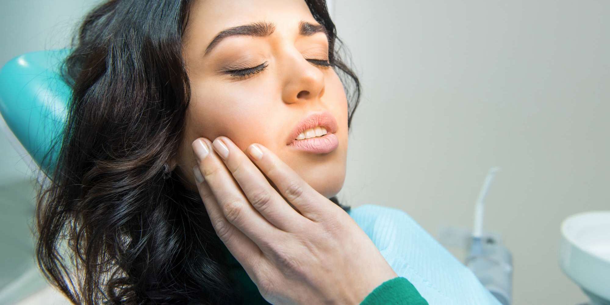 young woman having toothache