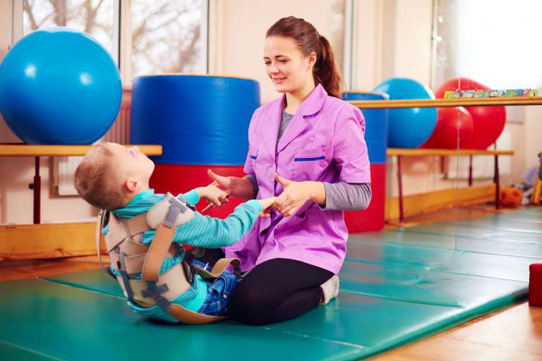 A photograph of a child having physical therapy, similar to what a child with cerebral palsy might have.