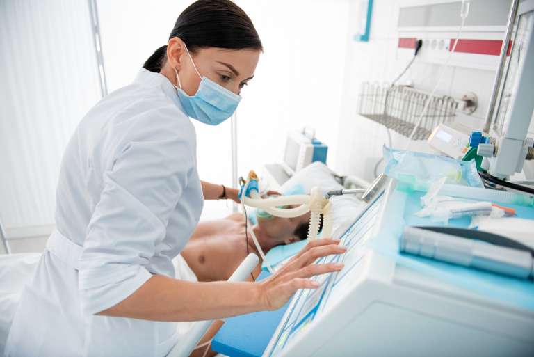 A photograph of a nurse operating a ventilator, to supplement a story about a patient who was incubated incorrectly